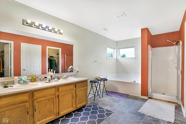 bathroom featuring plus walk in shower and vanity