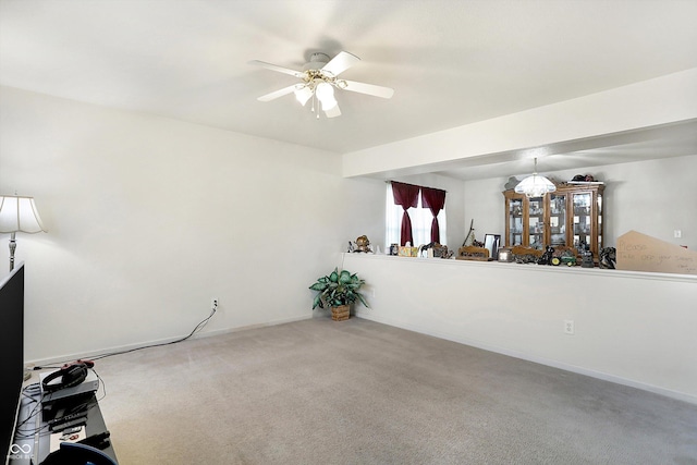 unfurnished room with ceiling fan and carpet