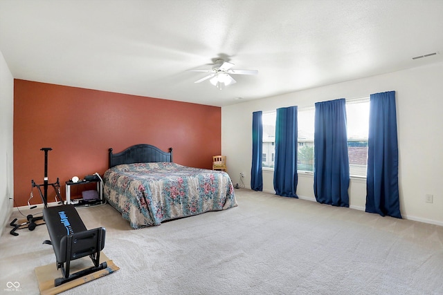 bedroom featuring light carpet and ceiling fan