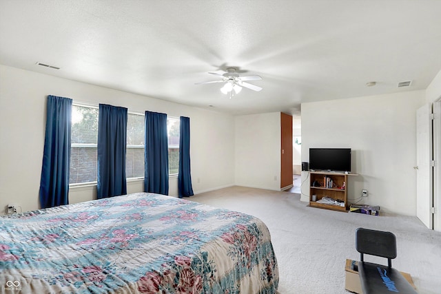 bedroom with ceiling fan and light colored carpet