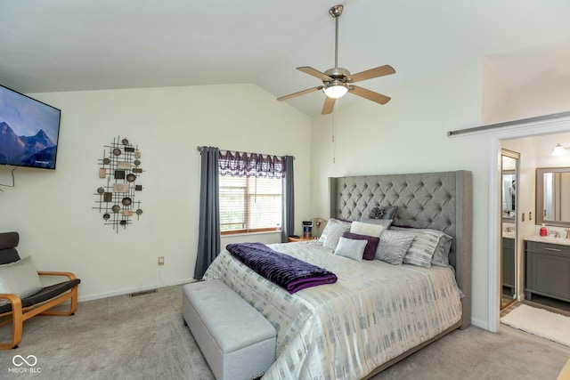 bedroom featuring ensuite bathroom, ceiling fan, vaulted ceiling, and light colored carpet