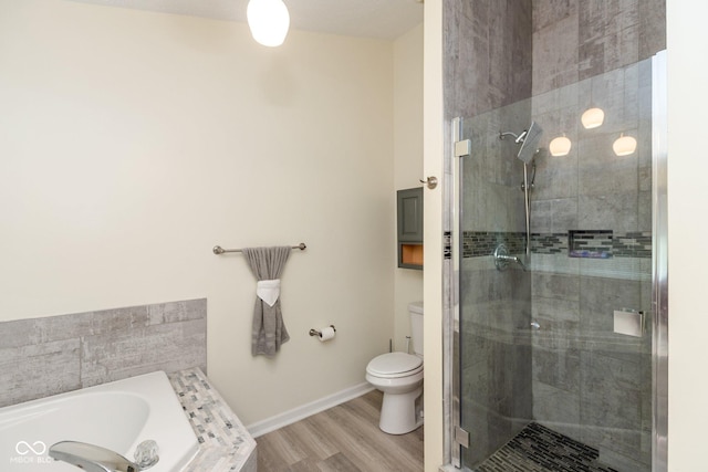 bathroom with toilet, wood-type flooring, and independent shower and bath