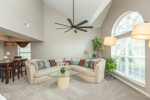 living room with carpet floors, ceiling fan, and a healthy amount of sunlight