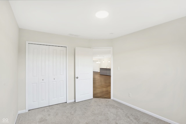 unfurnished bedroom featuring a closet and carpet floors