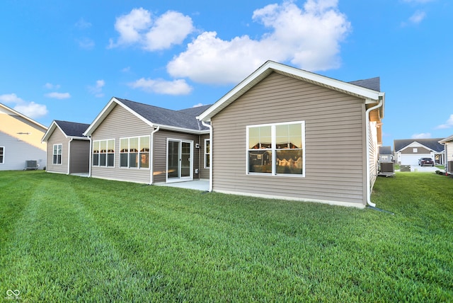 back of house with a patio area, a yard, and central air condition unit