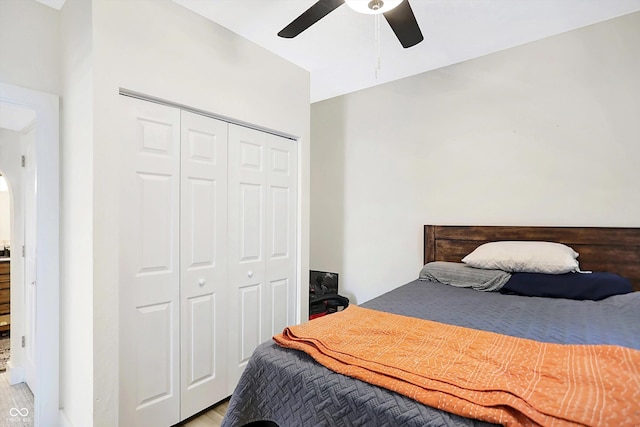 bedroom with ceiling fan, a closet, and light hardwood / wood-style floors