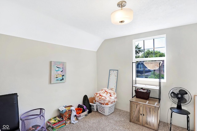 playroom featuring light carpet and vaulted ceiling