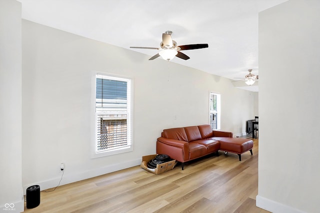 living room with light hardwood / wood-style floors, plenty of natural light, and ceiling fan