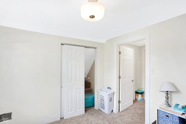 interior space with light carpet and a closet