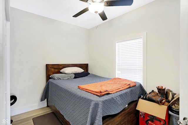 bedroom with ceiling fan and light hardwood / wood-style flooring