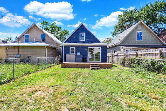 rear view of house with a lawn and a wooden deck