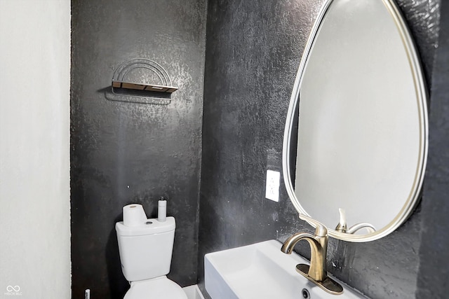 bathroom featuring sink and toilet