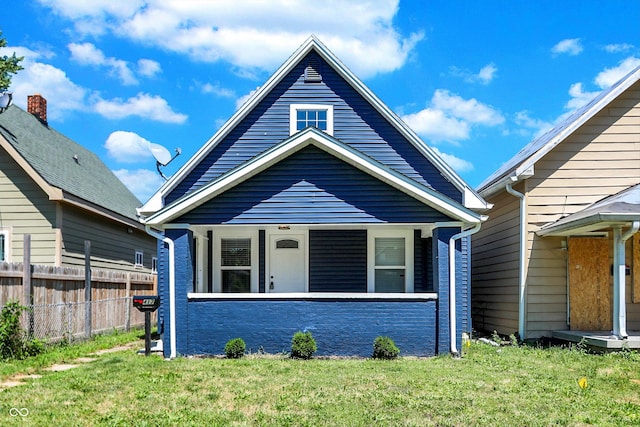 bungalow-style home with a front yard and a porch