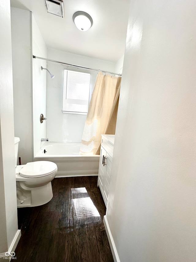 full bathroom with vanity, toilet, wood-type flooring, and shower / bath combination with curtain