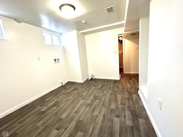 laundry area with dark wood finished floors, hookup for a washing machine, visible vents, and baseboards