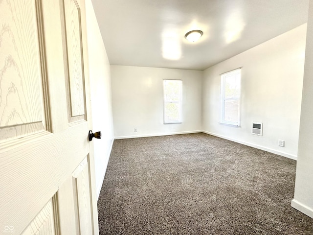 empty room with carpet and baseboards