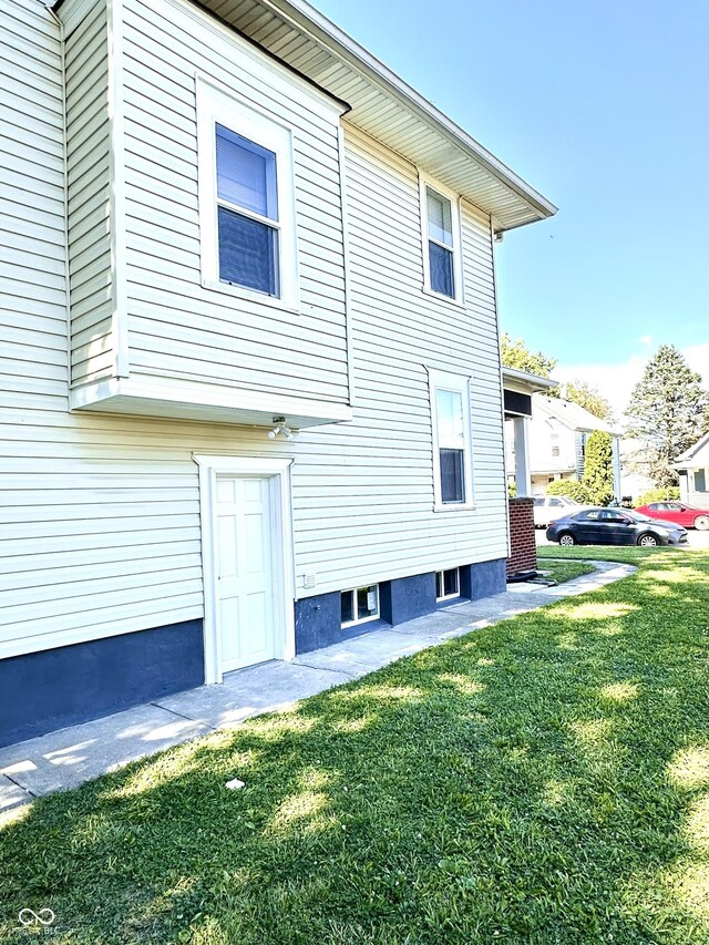 view of side of property with a lawn