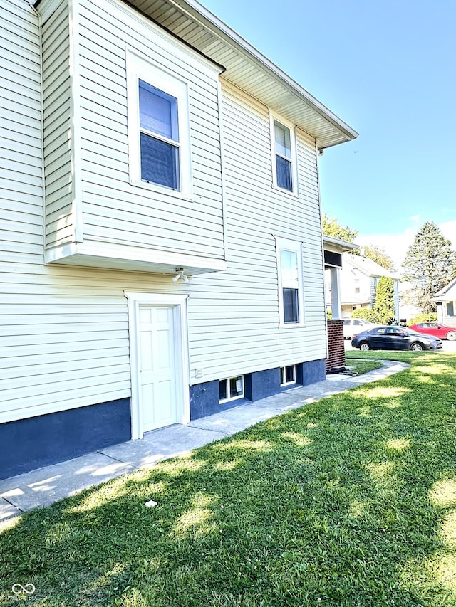 back of house with a lawn