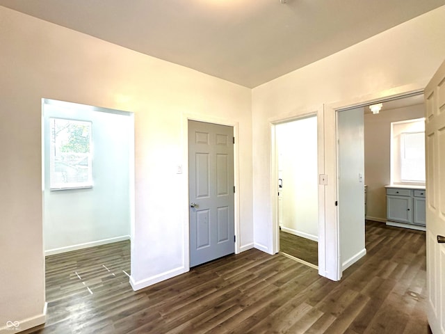 unfurnished bedroom with dark wood-style floors and baseboards