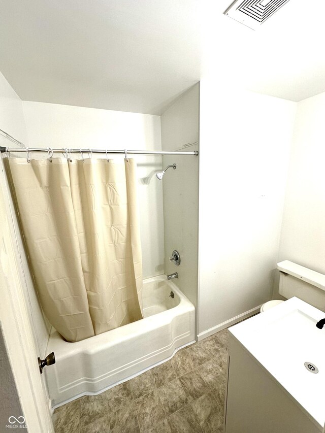 bathroom featuring tile patterned flooring, toilet, and shower / tub combo with curtain