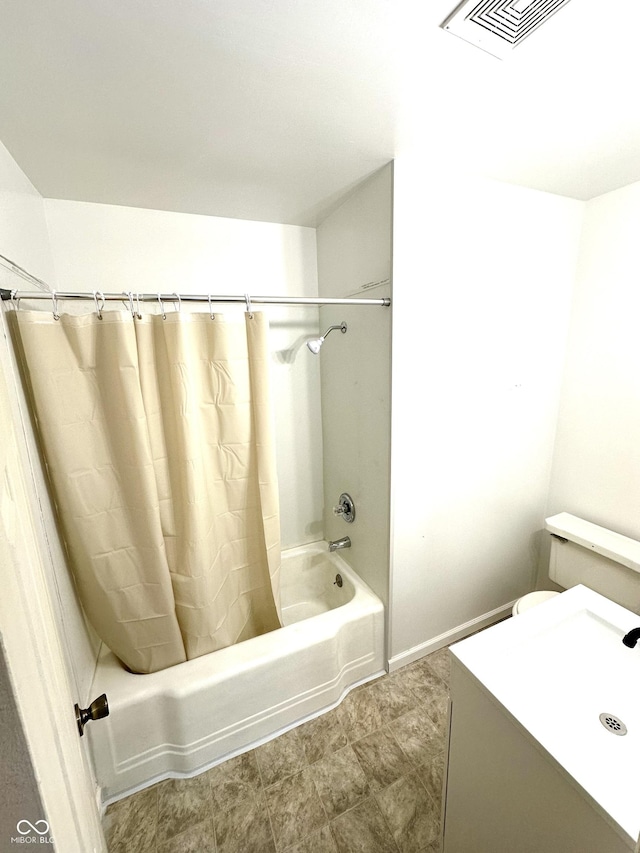 bathroom featuring toilet, visible vents, shower / tub combo with curtain, and vanity