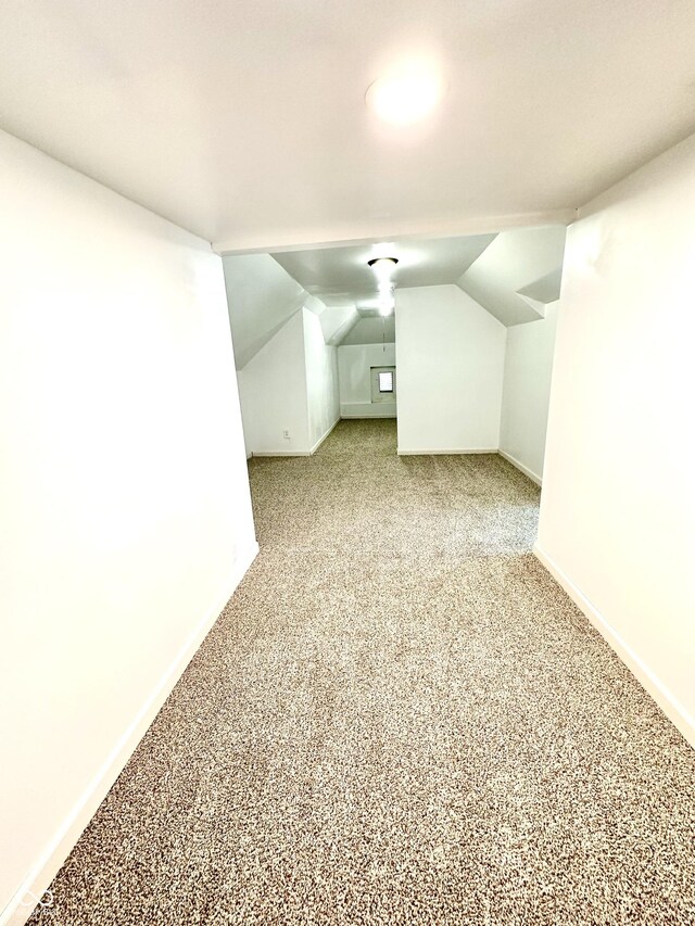 additional living space with carpet floors and lofted ceiling