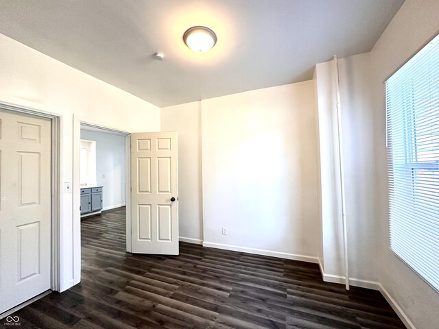 empty room with dark hardwood / wood-style floors