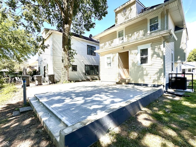 back of property featuring central AC