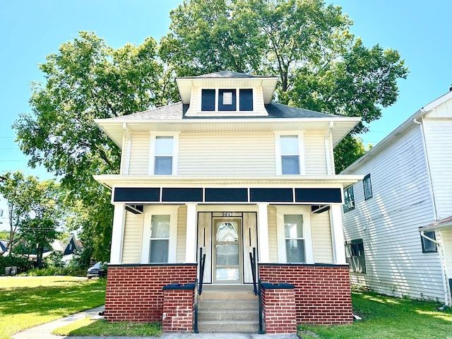 view of front of property featuring a porch and a front lawn