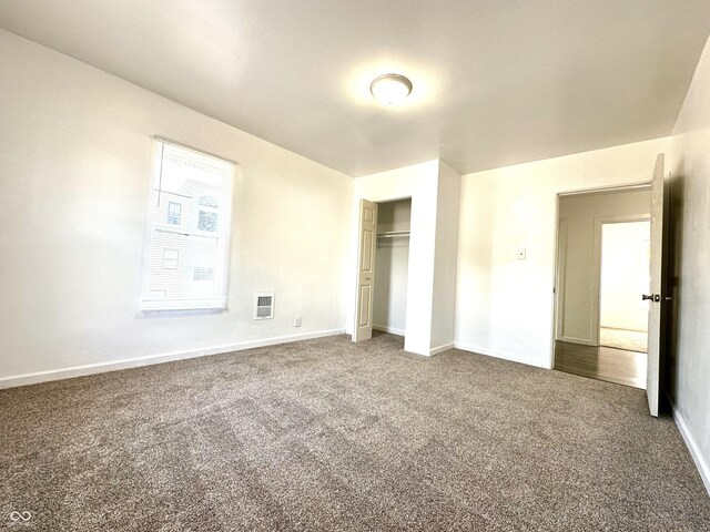 unfurnished bedroom featuring carpet and a closet