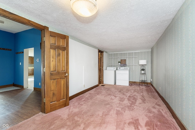 interior space with carpet, washing machine and clothes dryer, and a textured ceiling