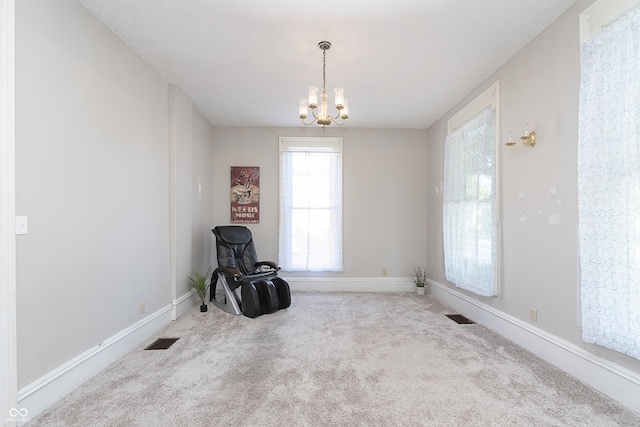 miscellaneous room featuring carpet flooring and a notable chandelier