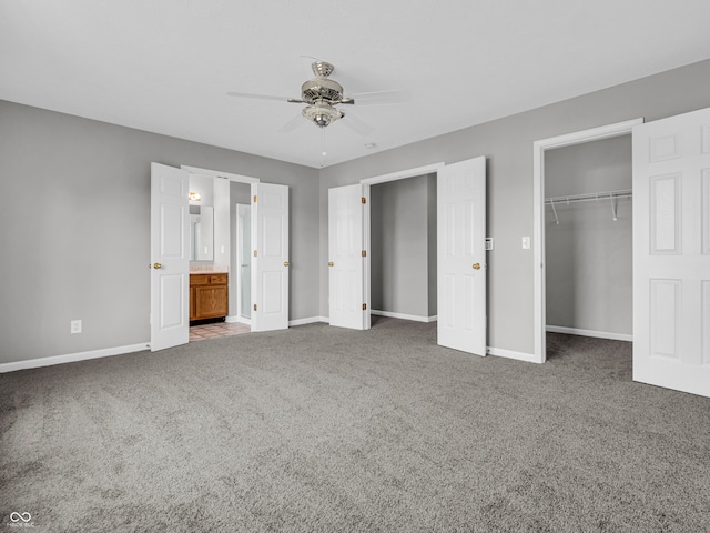 unfurnished bedroom with light carpet, a closet, ensuite bathroom, and ceiling fan