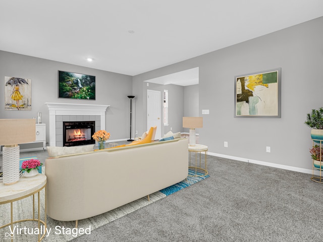 carpeted living room with a tiled fireplace