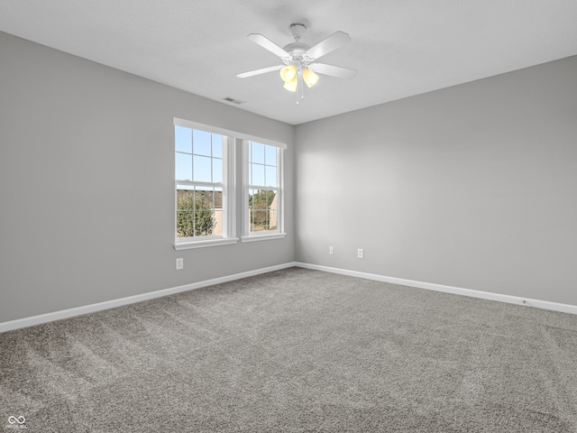 spare room with carpet and ceiling fan