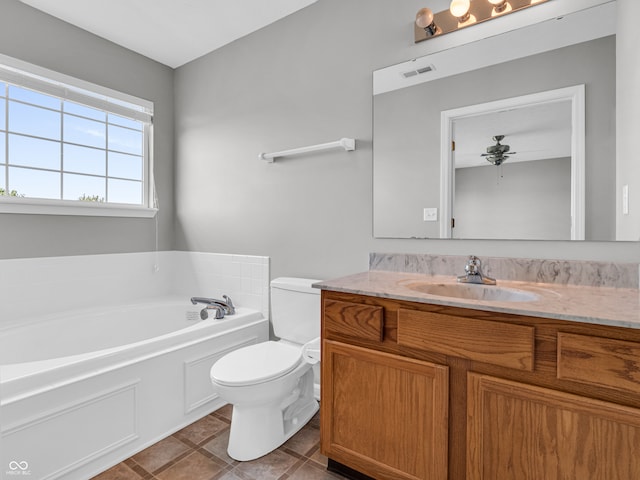 bathroom featuring a bathtub, ceiling fan, toilet, vanity, and tile patterned floors