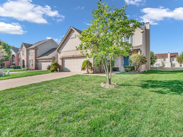 view of front of property featuring a front yard and a garage