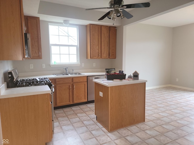 kitchen featuring white gas range oven, sink, a center island, stainless steel dishwasher, and ceiling fan