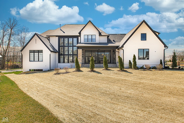 view of front of home featuring a sunroom and a front yard