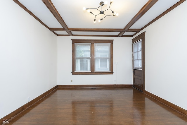 spare room with coffered ceiling, dark wood-type flooring, beamed ceiling, and an inviting chandelier