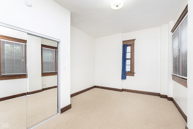 empty room featuring light carpet and a wealth of natural light