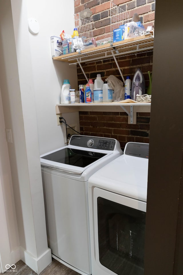 washroom featuring hardwood / wood-style floors and separate washer and dryer