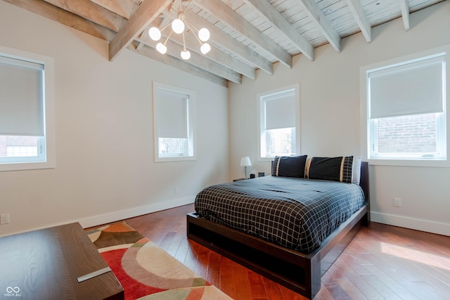 bedroom with beam ceiling, hardwood / wood-style floors, and wood ceiling