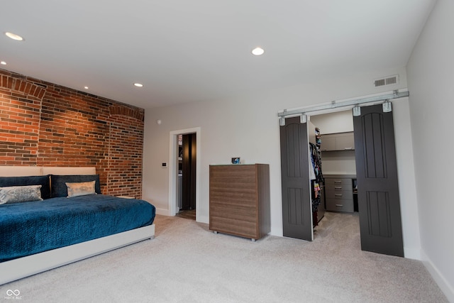 bedroom with a spacious closet, a closet, and light carpet