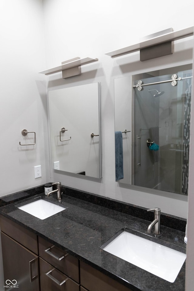 bathroom featuring vanity and a shower with shower door