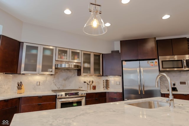 kitchen with dark brown cabinetry, stainless steel appliances, light stone counters, decorative light fixtures, and decorative backsplash