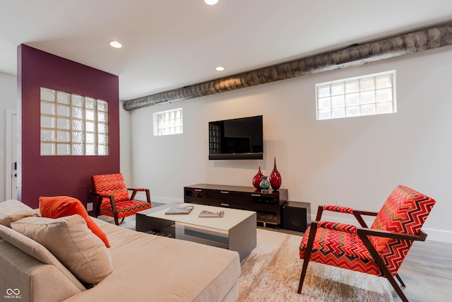 living room featuring a wealth of natural light and light hardwood / wood-style flooring