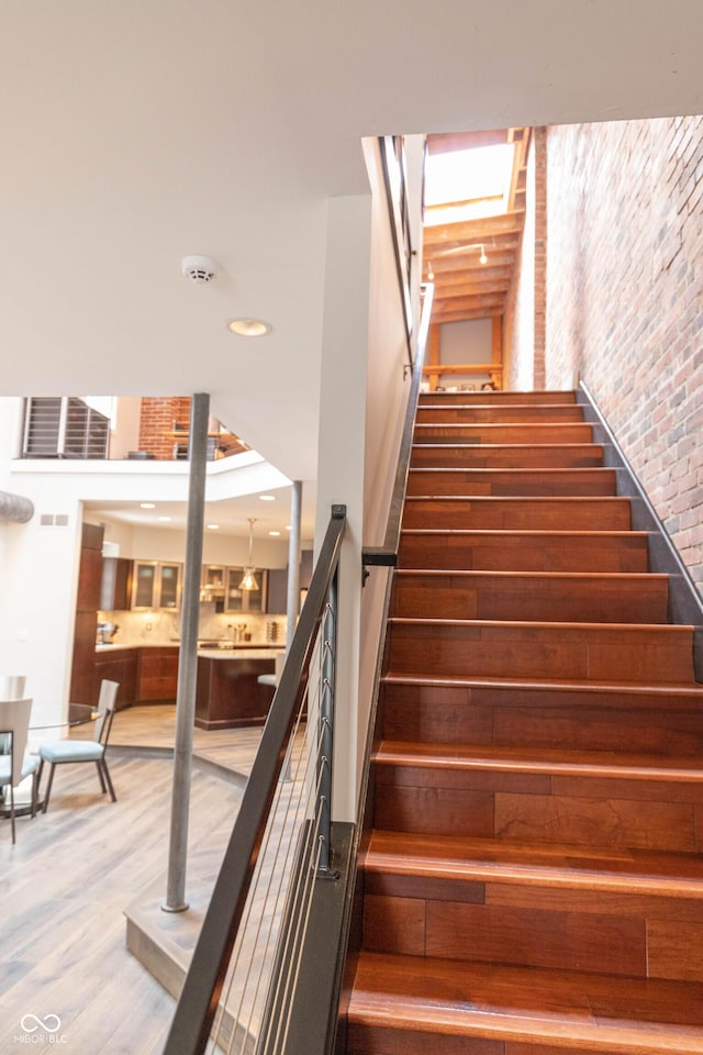 staircase with wood-type flooring