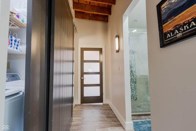 interior space with beam ceiling and washer and dryer