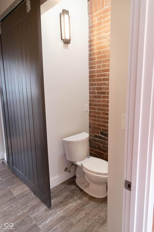 bathroom with hardwood / wood-style floors and toilet